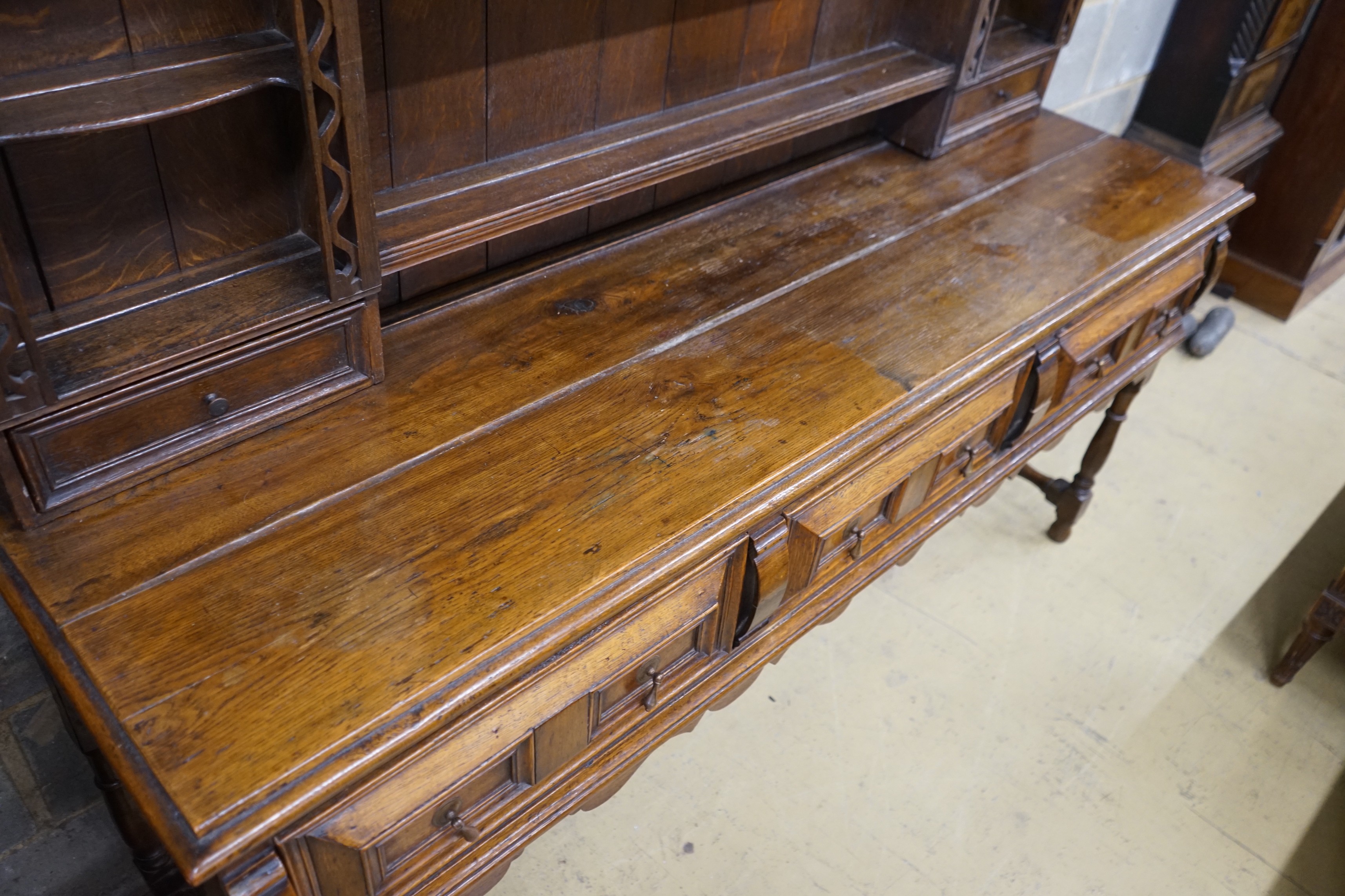 An 18th century style oak dresser with boarded rack, width 178cm, depth 51cm, height 200cm